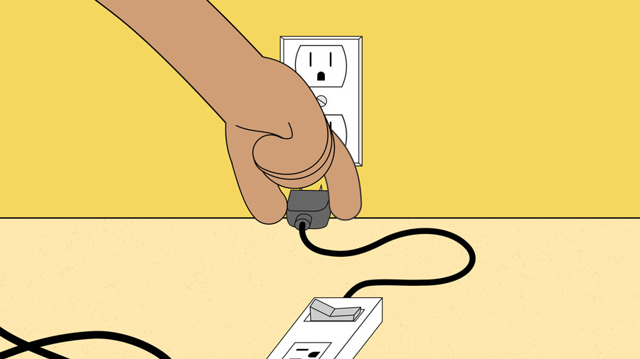 plugging the surge protector into the wall